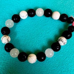 Black and white alternating bead bracelet made by me with stretchy cord